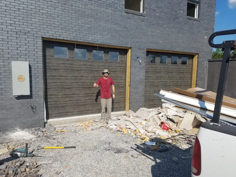 The same openings with new dark wood-look doors with a row of windows